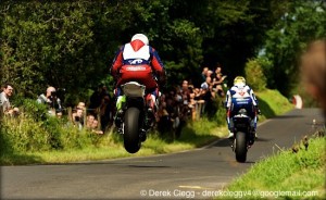 Michael Dunlop (MD Honda) gets big air as he chases down Tyco Suzuki's Guy Martin at the 2013 Armoy road races. Photo © Derek Clegg. All rights reserved.